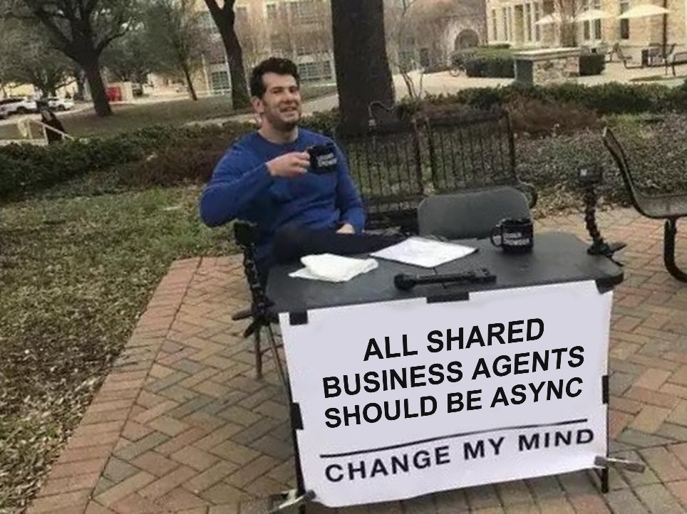 The Change my mind meme: a man at a table with a sign that reads All shared business agents should be async. Change my mind.